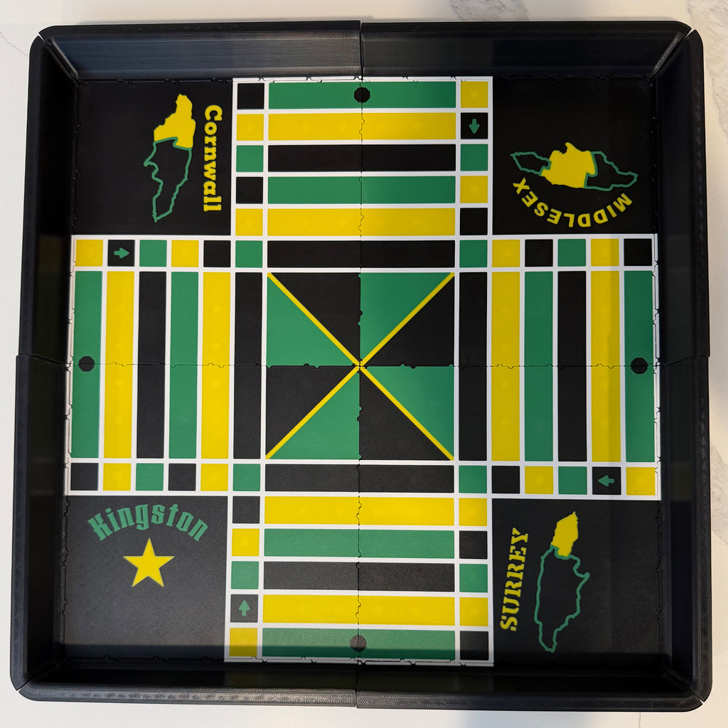 Top view of the Lock Pon Stop 16×16 modular magnetic Ludi board with Jamaican parish artwork in green, yellow, and black.