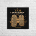 28 × 28 inch black and gold Di Ten Commandment Dem Jamaican Patois Christian canvas displayed on a white brick wall.
