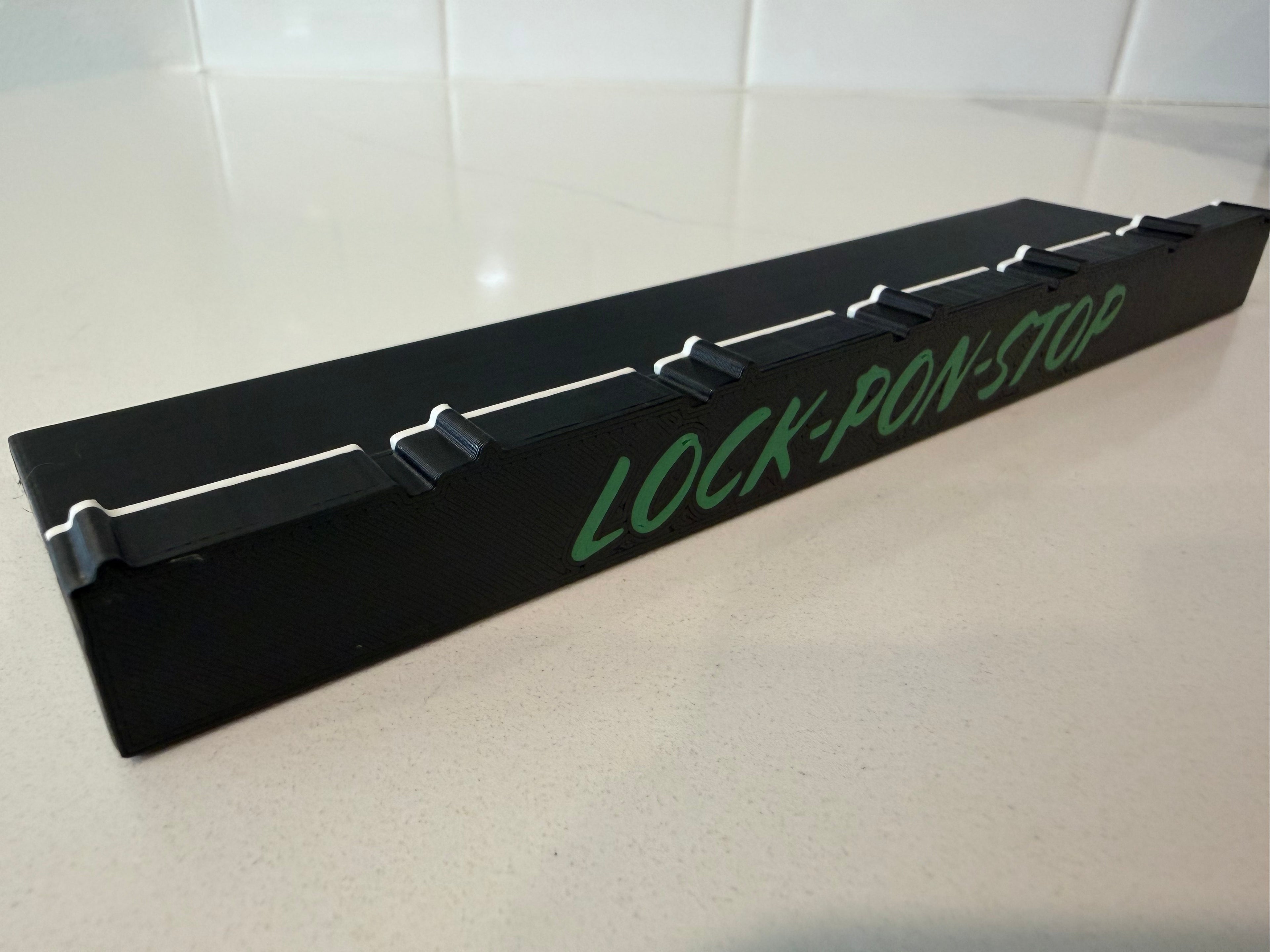 Branded Lock Pon Stop side wall panel for the 24x24 Modular Magnetic Ludi Board, featuring precision snap-together connections, built-in magnetic alignment, durable ASA construction, and a raised border to help keep game pieces on the board.