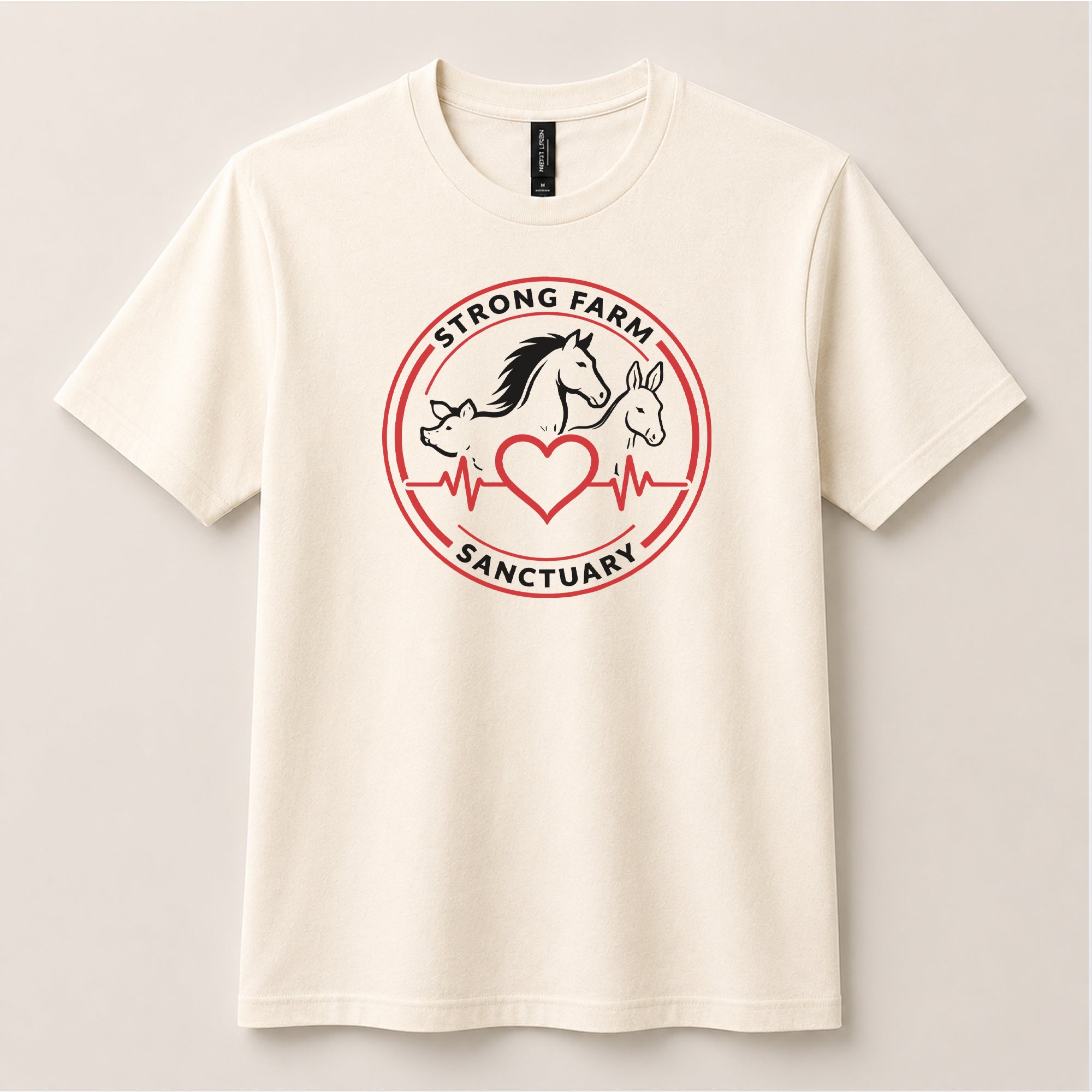Natural Next Level 6410 sueded t-shirt featuring the official Strong Farm Sanctuary logo printed on the front chest. The circular logo includes a horse, donkey, pig, heart, and heartbeat line representing the sanctuary's mission to rescue and care for farm animals.