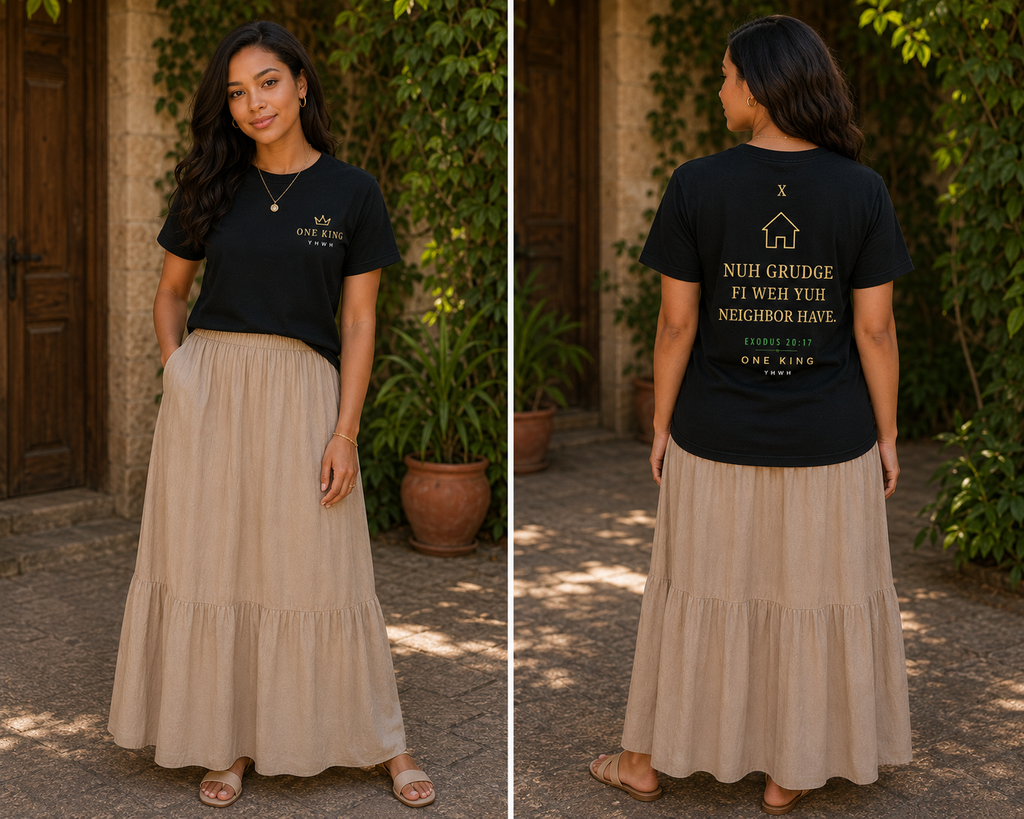 Woman wearing a black t-shirt with text and a beige skirt, standing in front of a stone wall and plants. Tenth Commandment Exodus 20:17 Nuh Grudge Fi Wei Yuh Neighbor Have