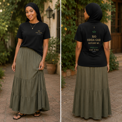 Woman wearing a black t-shirt with text and a green skirt outdoors. Di First Commandment Lock Pon Stop Shirt. No Odda God Before Mi. Exodus 20:3