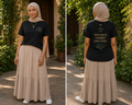 Woman wearing a black t-shirt with text and a beige hijab, standing outdoors. Seventh Commandment 7 Yuh nuh fi commit adultery Exodus 20:14 lock pon stop