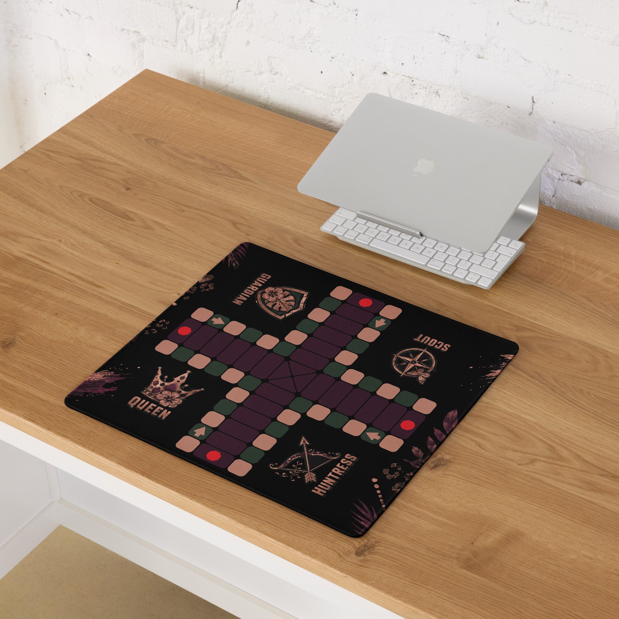 Compact 18 × 16-inch Jungle Queen Jamaican Ludi game board mouse pad displayed on a wooden computer desk.