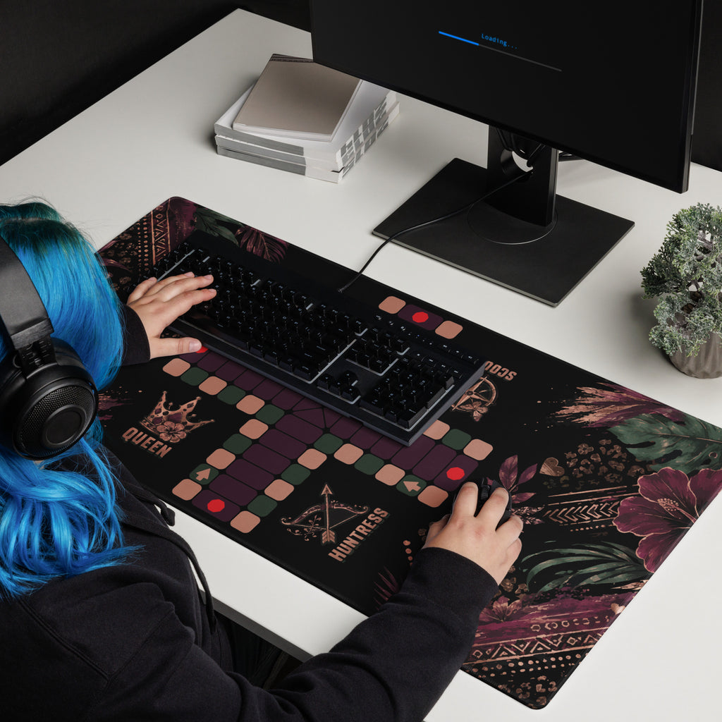 Lady with blue hair using the 36 × 18-inch Jungle Queen Jamaican Ludi mouse pad beneath a keyboard and mouse.