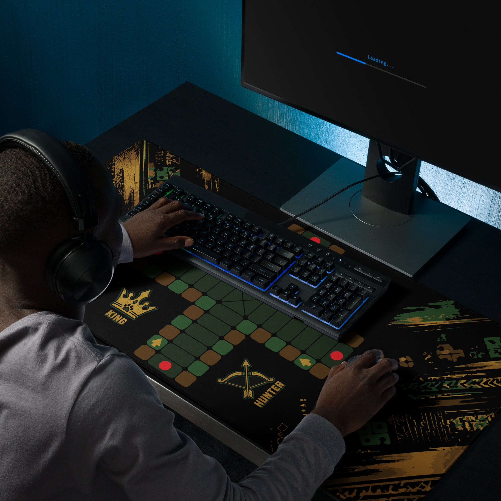 Person using the 36 × 18-inch Jungle Roles Jamaican Ludi mouse pad beneath a keyboard while gaming at a desktop computer.